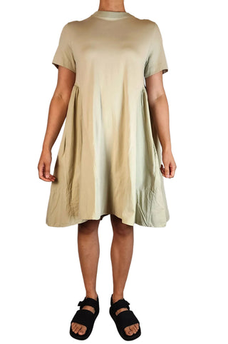 Beige dress worn by a person on a white background